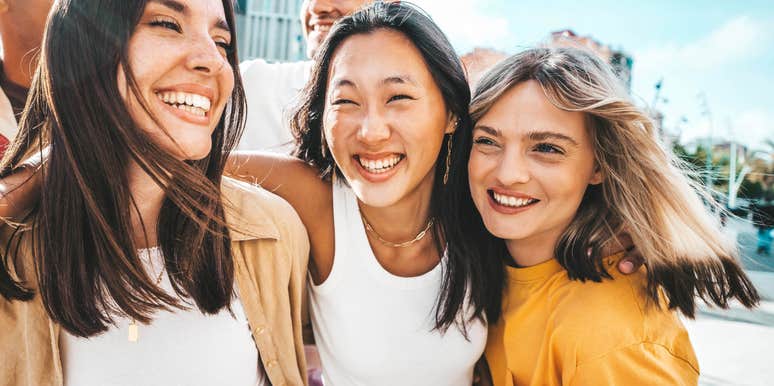 Woman who is great at reading a room embraces her friends and laughs