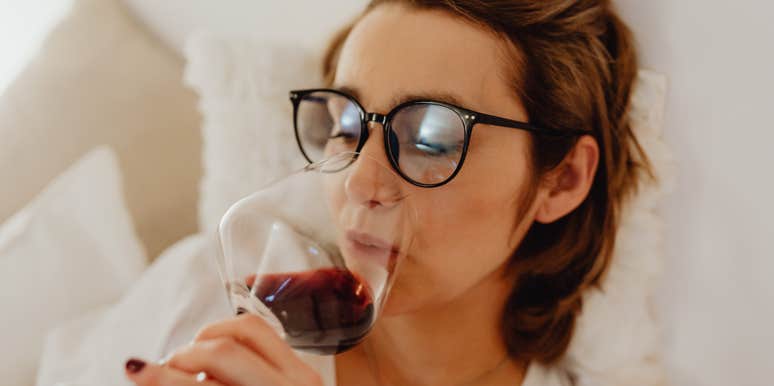 Woman can't relax without a glass of wine.