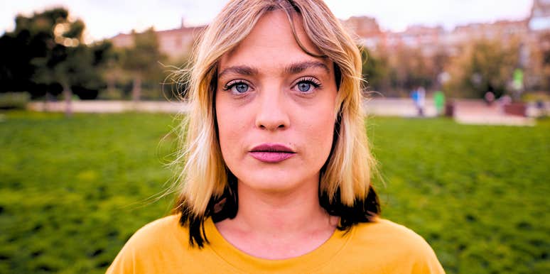 mentally and emotionally detached woman standing outside alone