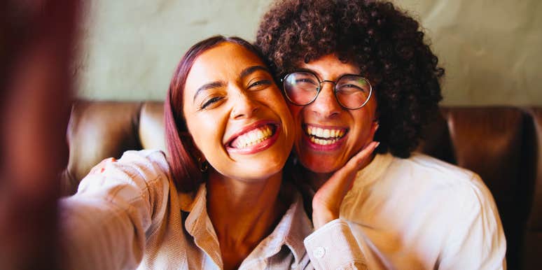 happy couple smiling big for a selfie