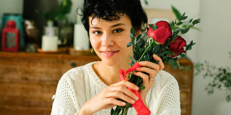 romantic woman holding flowers smiling