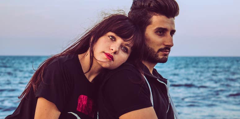 serious couple standing together looking unhappy