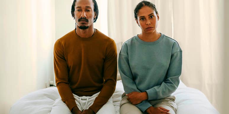 serious unhappy couple sitting next to each other feeling distant