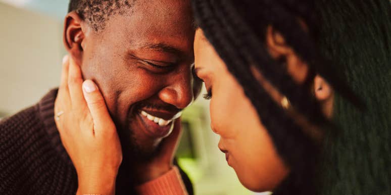 A man making his wife feel deeply loved sharing a peaceful moment of closeness in their home, symbolizing commitment, mutual care, and emotional security.