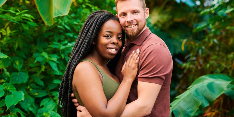 happy couple hugging and posing together outside