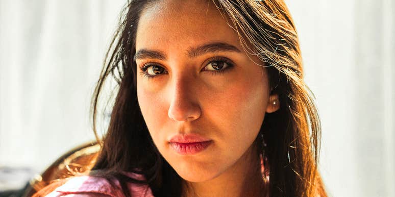 Woman's neutral, distant expression in close-up, hinting at the subtle signs of a fading friendship