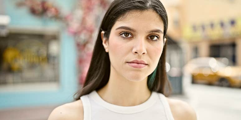 mentally and emotionally exhausting woman looking directly into camera