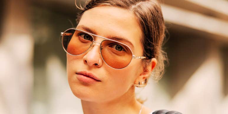 Her cool, guarded stare over sunglasses hints at the quiet negativity some people carry into relationships.