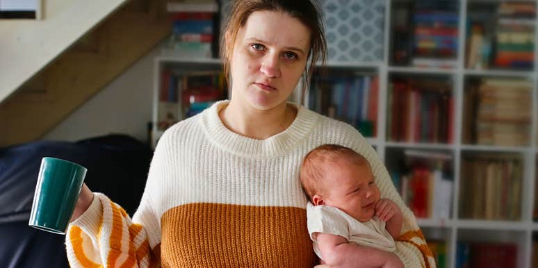 Woman holding a baby who is losing her capacity for joy 
