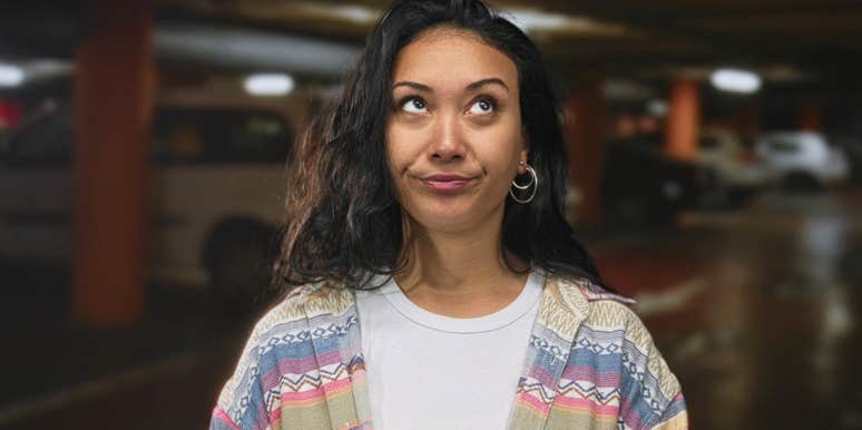 Young woman with low vibes rolling her eyes 