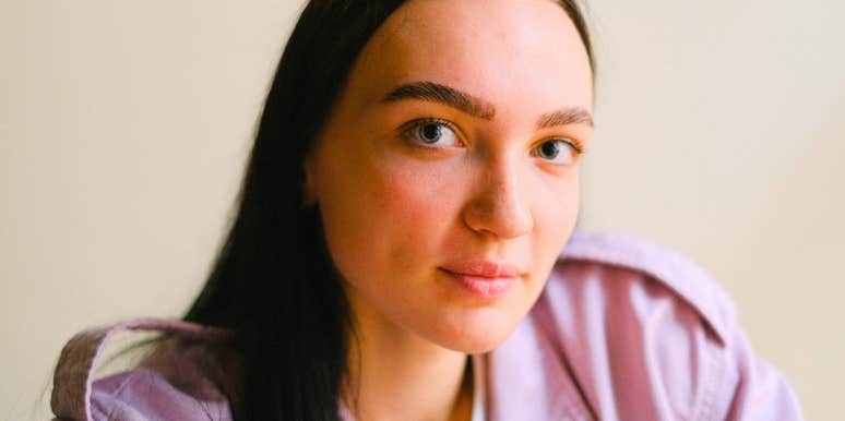 gentle empathetic woman smiling slightly