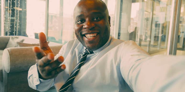smiling man finding meaning at his job feeling happy