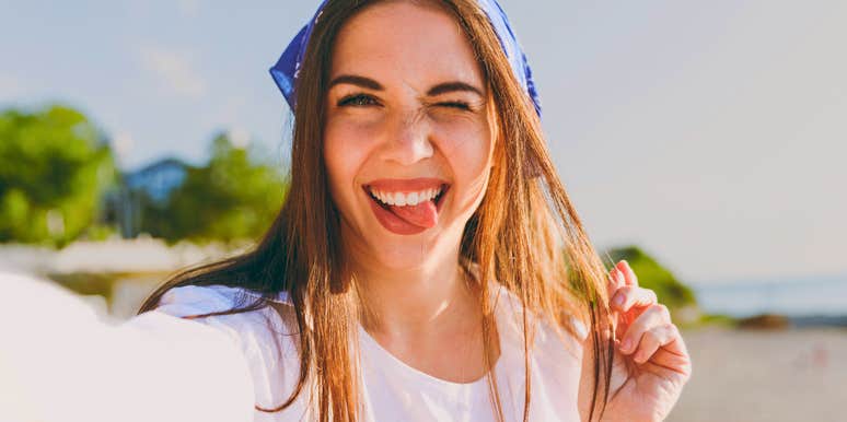 unbothered woman taking a silly selfie