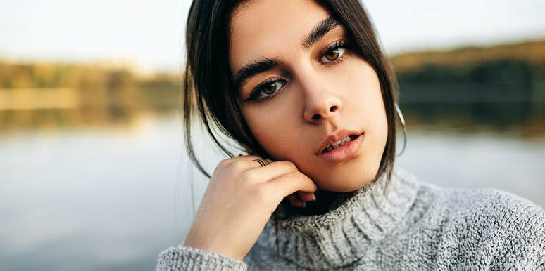 woman who is lost in her mind outdoors by a lake