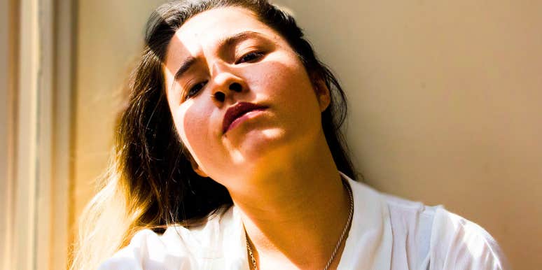 self-sabotaging empathic woman looking miserable