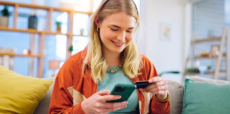 naive young woman holding credit card to borrow money