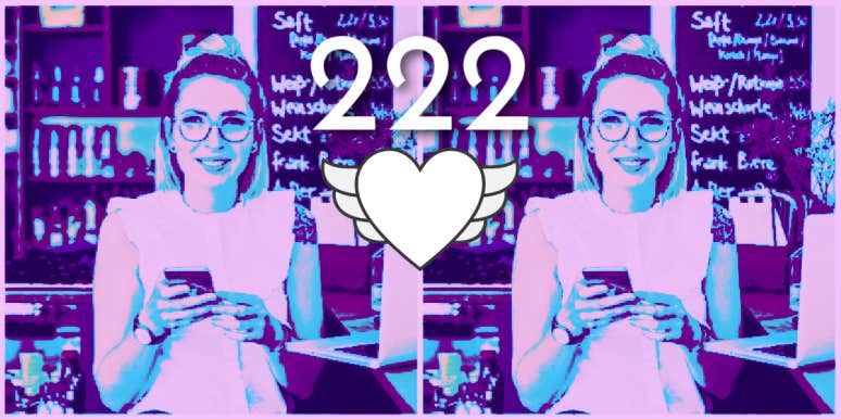 woman smiling after seeing angel number 222 on her smartphone