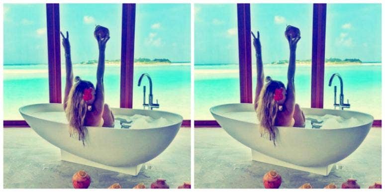 woman soaking in bath with roses woman soaking in bath with roses