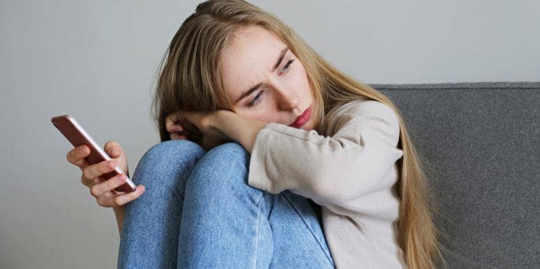3 Brutally Honest Reasons Men Don't Call When They Say They Will sad woman holding phone
