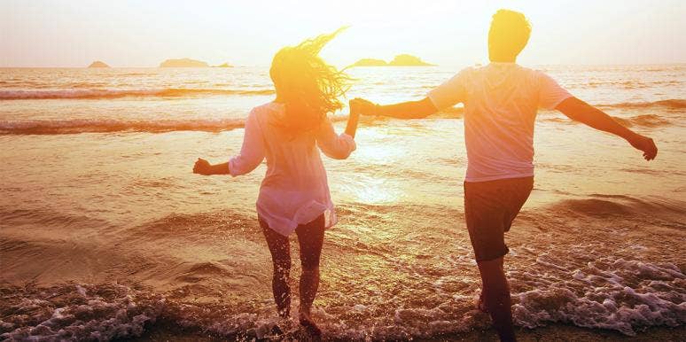 4 Best Honeymoon Destinations Around The World man and woman running into ocean