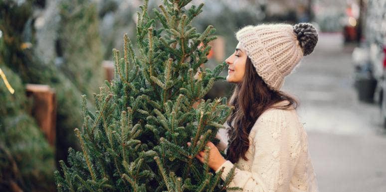 woman smelling christmas tree