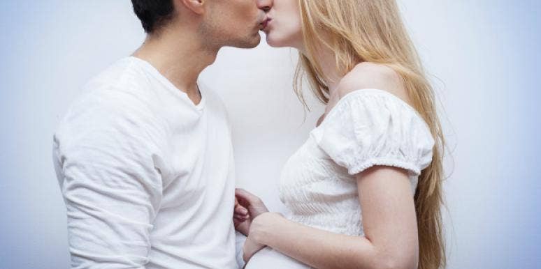 pregnant couple kissing pregnant couple kissing