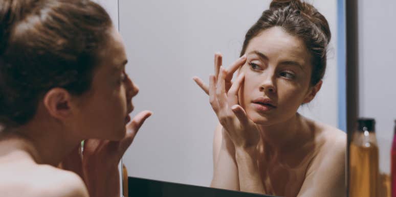 5 Bad Habits That Reveal A Lot About Your Hygiene woman in mirror