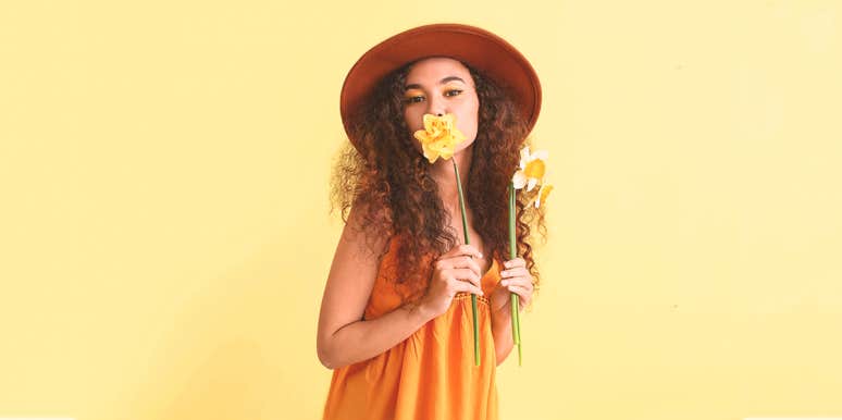 5 Ways To Make Your Life A Little More Interesting Every Day woman holding on a flower