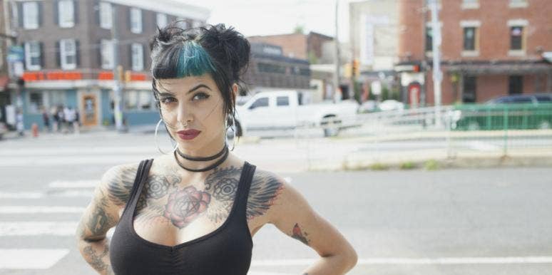 Why Woman's Gym Said Her Tank Top Made People Uncomfortable woman in low-cut tanktop and blue hair