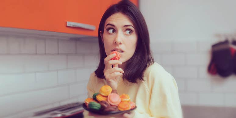 7 Signs You Have A Really Dangerous Sugar Addiction woman eating sweets