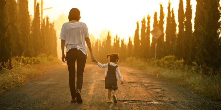 7 Reasons Introverts Make Great Parents, According To Science mom and daughter holding hands walking