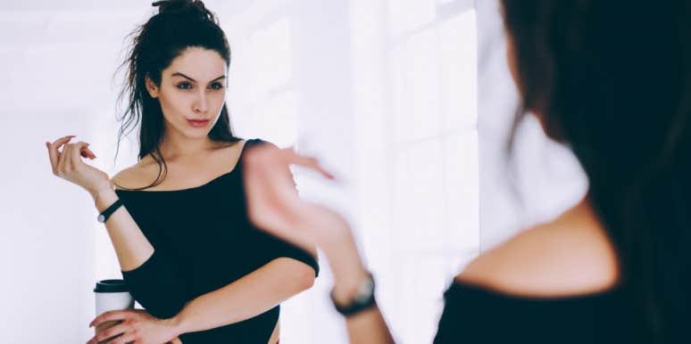 7 Signs A Woman You Know Is A Total Narcissist woman looking in mirror