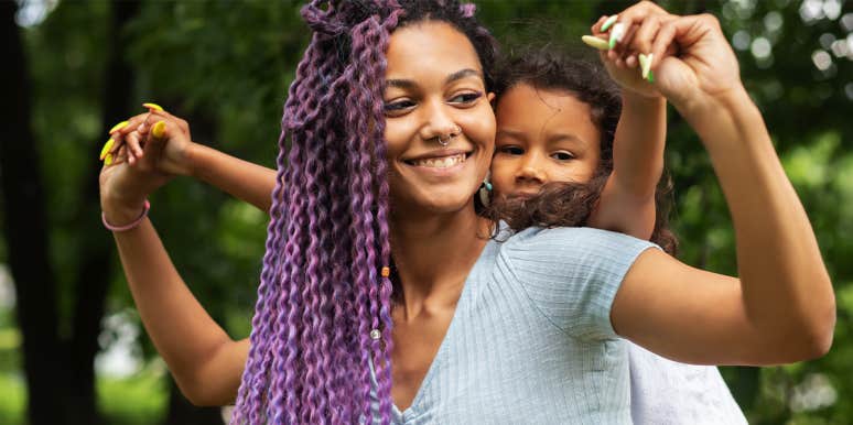 7 Things Good Moms Do (That I'm Not Doing Anymore) mom carrying daughter