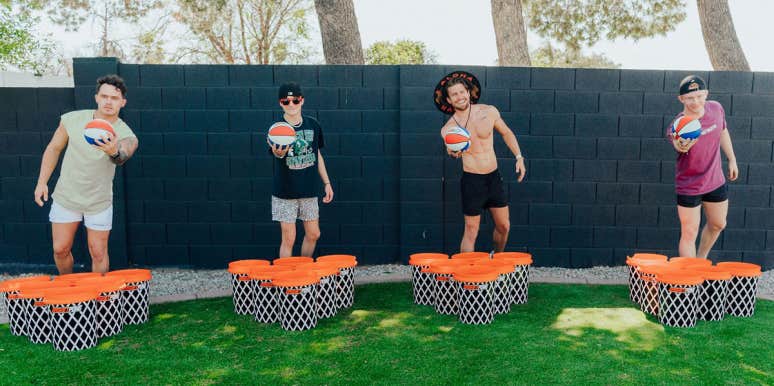 BasketPong Is This Summer's Most Loved Outdoor Party Game four men throwing balls at basketpong