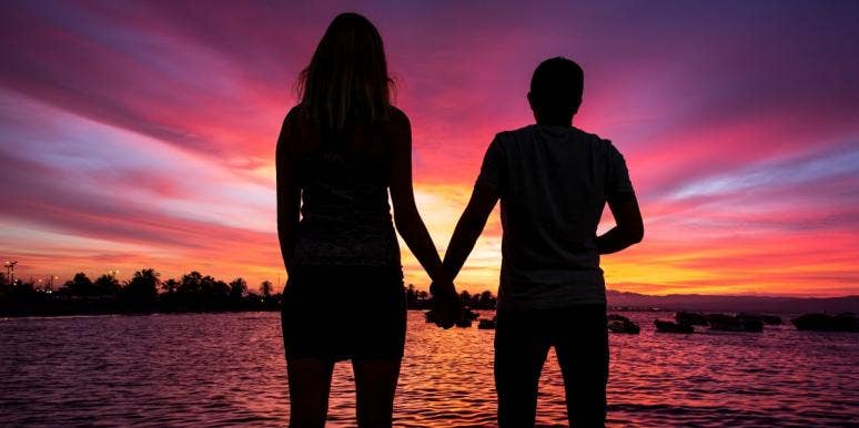 The Unsexy Truth About What Your Dates Are Going To Look Like In A Future Climate Crisis Couple gazing into the ocean at night holding hands