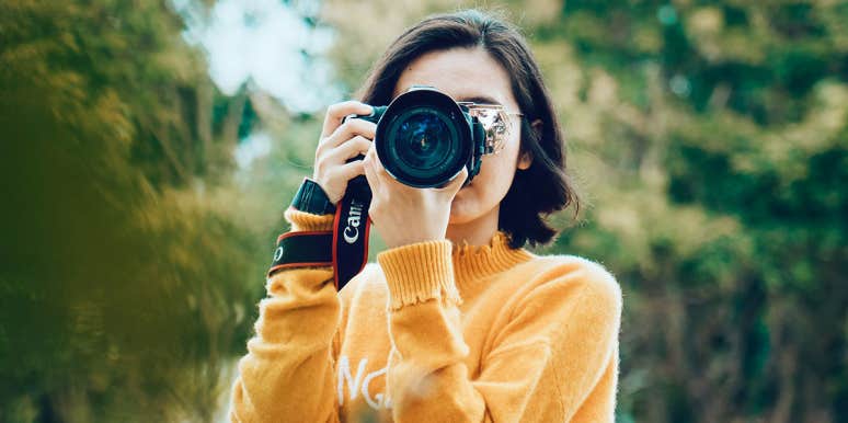This Lifetime Cloud Backup Plan Duo Will Keep Your Summer Travel Memories Secure For Years To Come woman taking photo