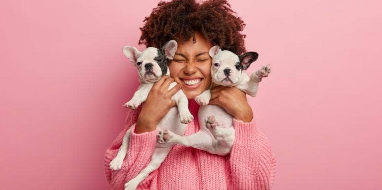 Best Girl Dog Names That Are As Unique As Your Puppy woman holding two puppies