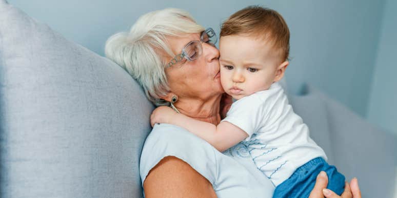 grandma kisses and holds her grandson