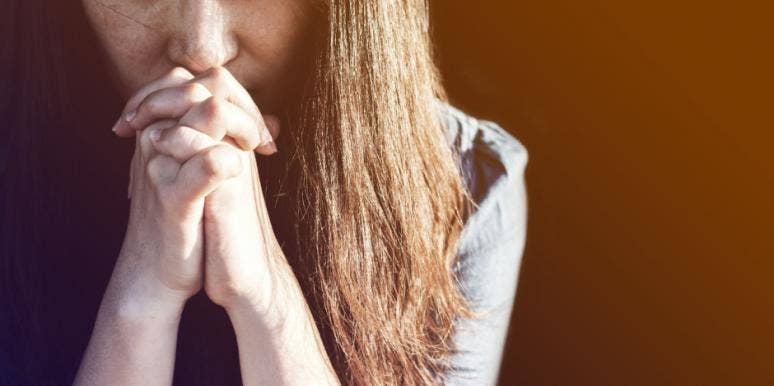 Distraught woman praying Distraught woman praying