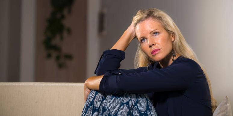 Signs Of A Midlife Crisis & How To Know When It's Coming To An End Middle aged woman with hand on head