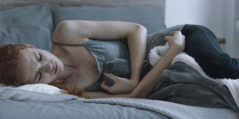 What It's Like To Have An Abortion One Month After Turning 13 woman on bed crying