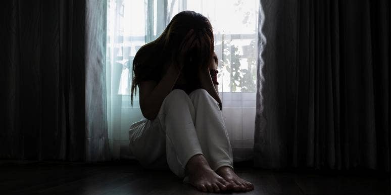 I Said I Would Never Put Up With A Physically Abusive Relationship — Until I Was In One woman in bed with head in knees