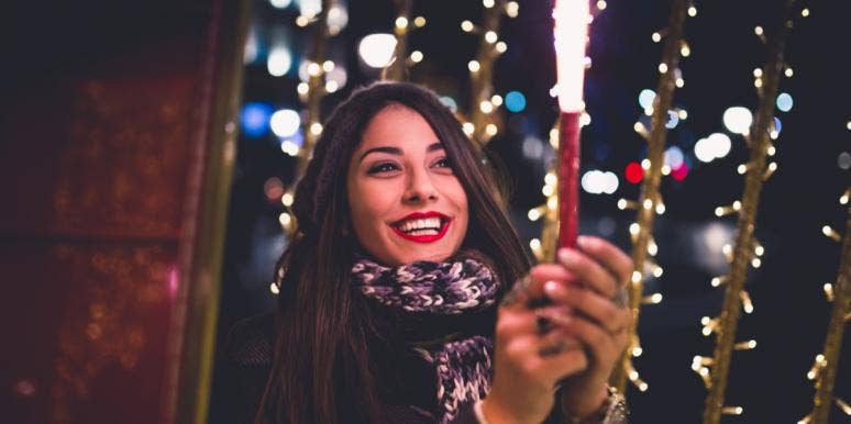 An Actual New Year’s Resolution woman holding sparkler