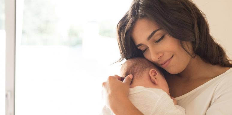 50 Male & Female Angel Names For Boys & Girls woman holding a newborn baby