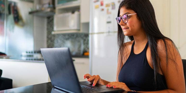 Angel Number 44 Meaning & Spiritual Symbolism woman in glasses on the computer
