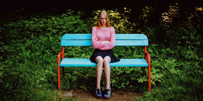 angry after a mutual breakup angry woman sitting on a bench with arms crossed