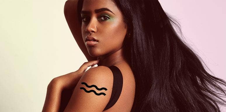 Aquarius Woman: Love, Personality Traits And Facts woman with aquarius tattoo on her arm