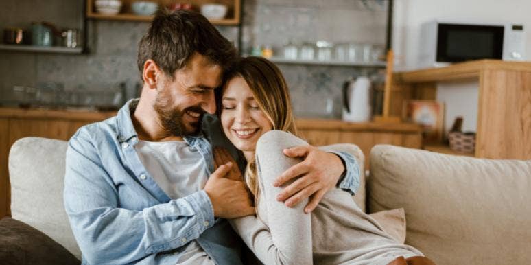 How Each Zodiac Sign Shows Affection When They're In Love man and woman cuddling on couch in love