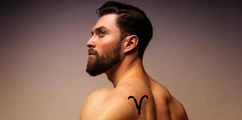 man with aries tattoo on shoulder
