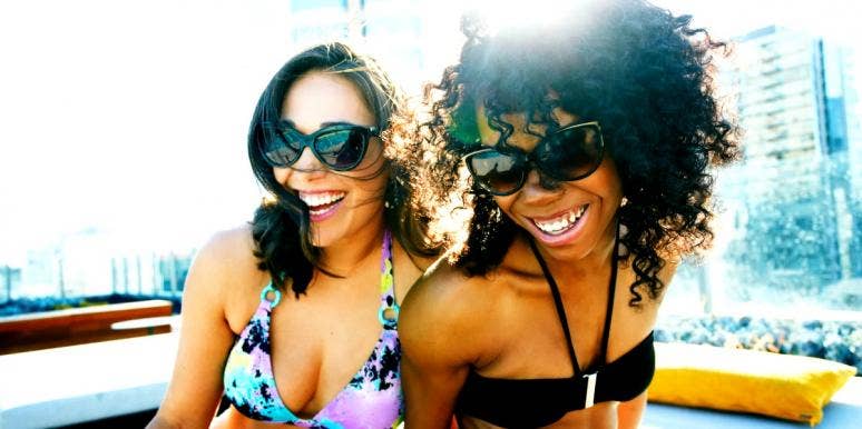 Aries Zodiac Sign: 10 Best & Worst Personality Traits two friends laughing in bathing suits